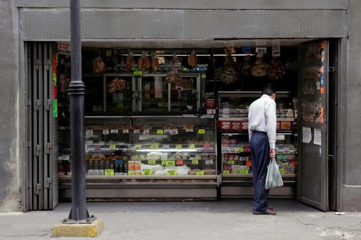 A man looks at prices in a grocery store in downtown Caracas, Venezuela March 10, 2017. REUTERS/Marco Bello