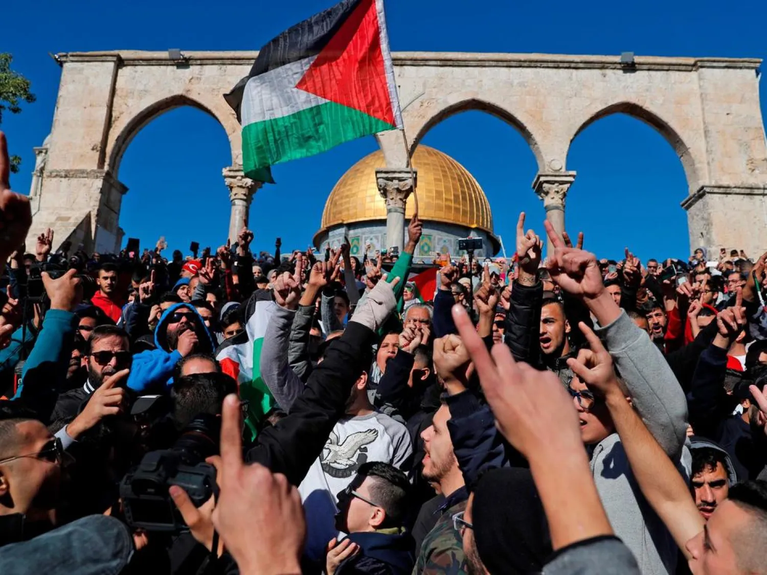 Palestinian shout slogans during Friday prayer in front of the Dome of the Rock mosque at the al-Aqsa mosque compound in the Jerusalem's Old City on December 8, 2017. (AFP)