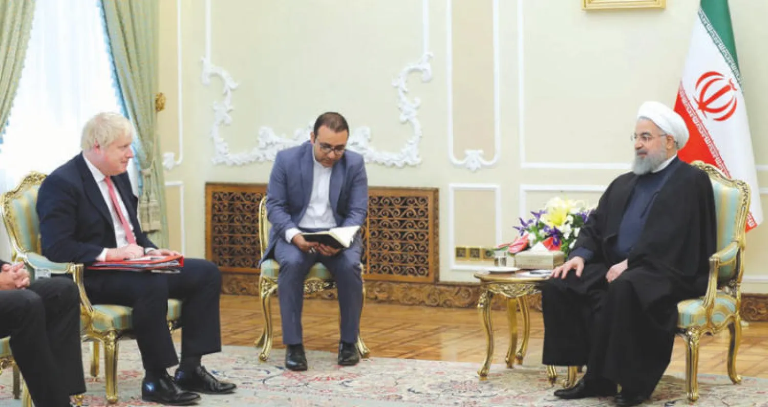 روحاني لدى استقباله جونسون في طهران أمس (رويترز)