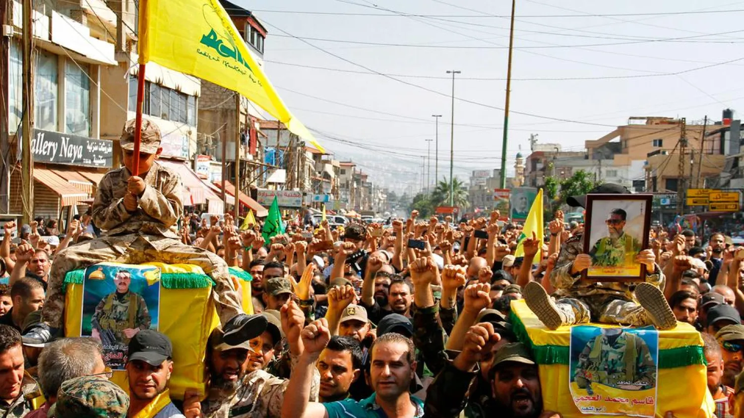 Hezbollah supporters carry the coffins of fighters killed in an assault led by the group on extremists in the mountainous Jurud Arsal region on the Lebanon-Syria border during their funeral in a southern suburb of Beirut on July 31, 2017. AFP