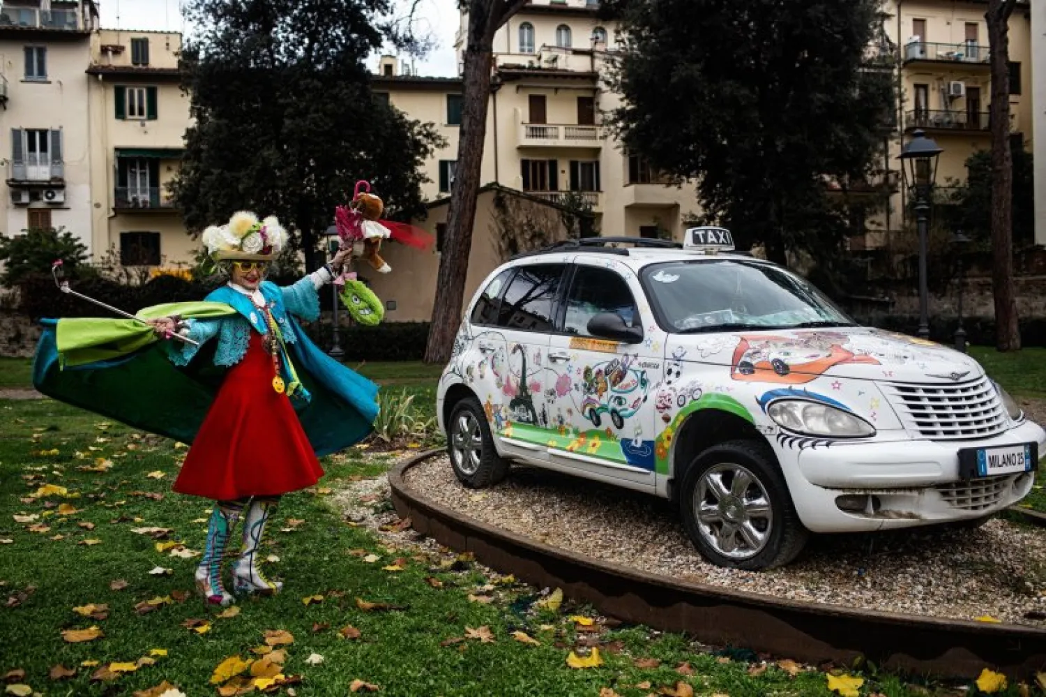 Caterina Bellandi dancing around her first taxi, now a monument in the Garden of Horticulture in Florence. Nadia Shira Cohen for The New York Times