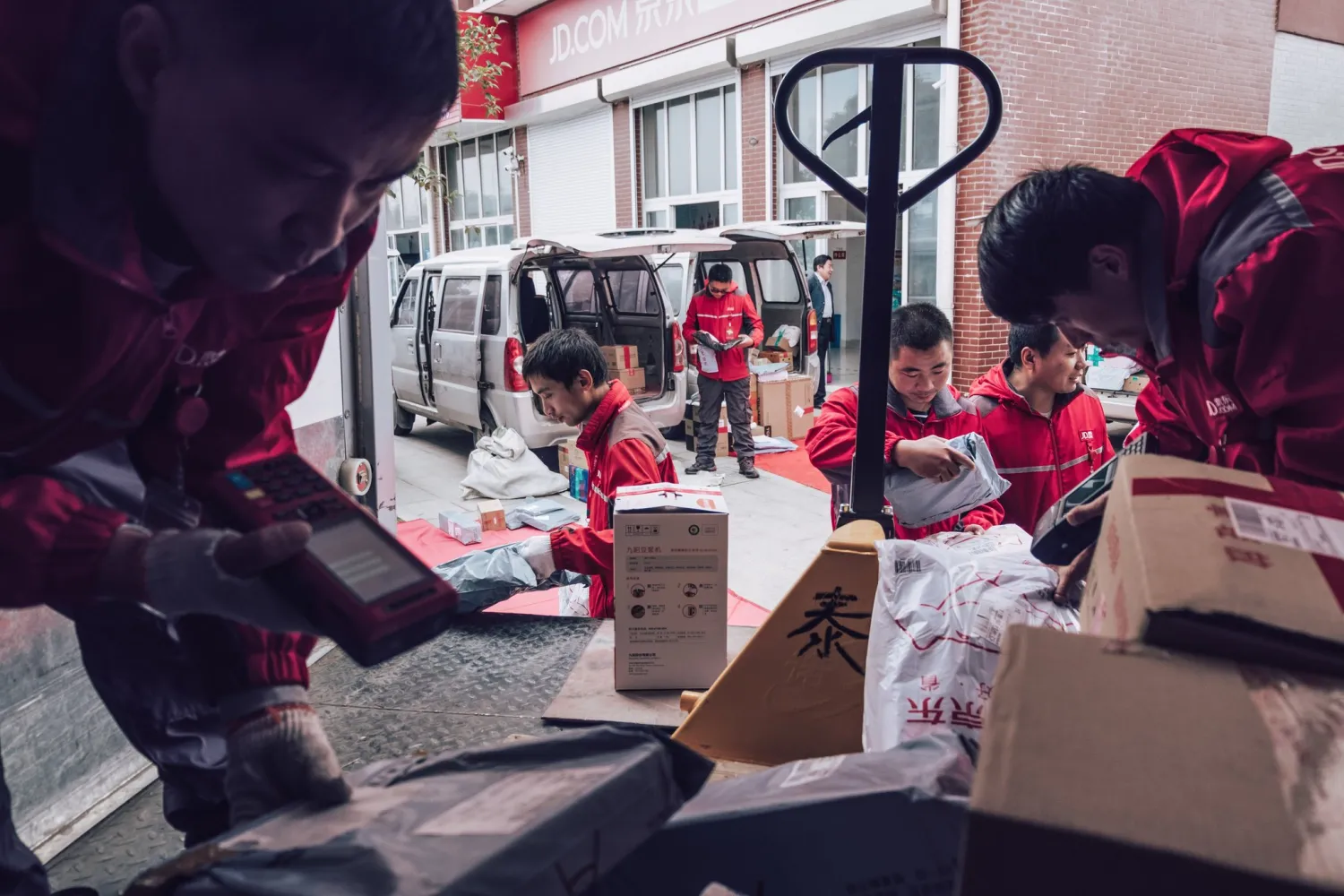 Delivery personnel for JD.com, a Chinese e-commerce company, sorting packages in Liangduo in eastern China. Online shopping has expanded into less developed parts of the country as incomes have risen. Credit Photographs by Yuyang Liu for The New York Times