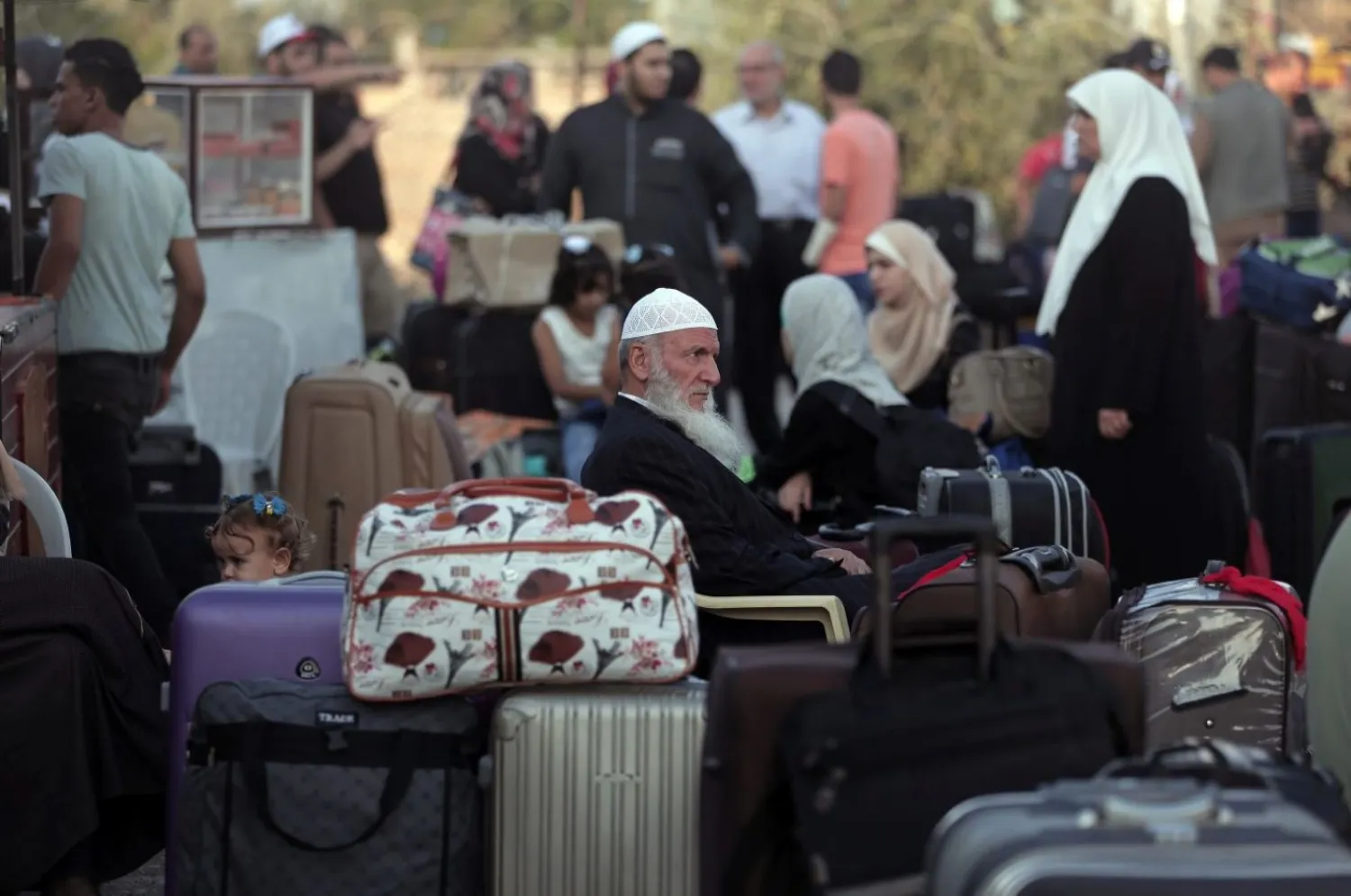 Palestinians wait with their luggage to cross the border into Egypt, at the Rafah crossing border in the southern Gaza Strip, Saturday, Sept. 3, 2016. Khalil Hamra, AP