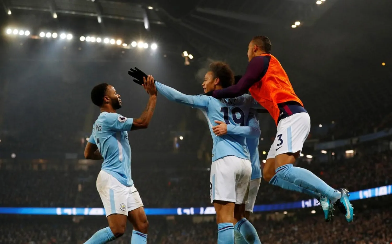 Manchester City's Raheem Sterling celebrates with teammates after scoring their third goal against Tottenham on December 16. (Reuters)