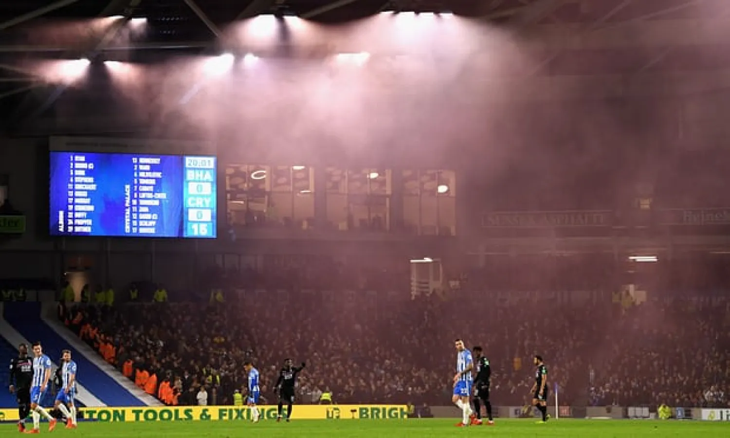  Smoke from flares drifts over the pitch at Brighton v Crystal Palace – but initial reports that away fans had arrived with knives and knuckle-dusters have since been withdrawn. Photograph: Mike Hewitt/Getty Images
