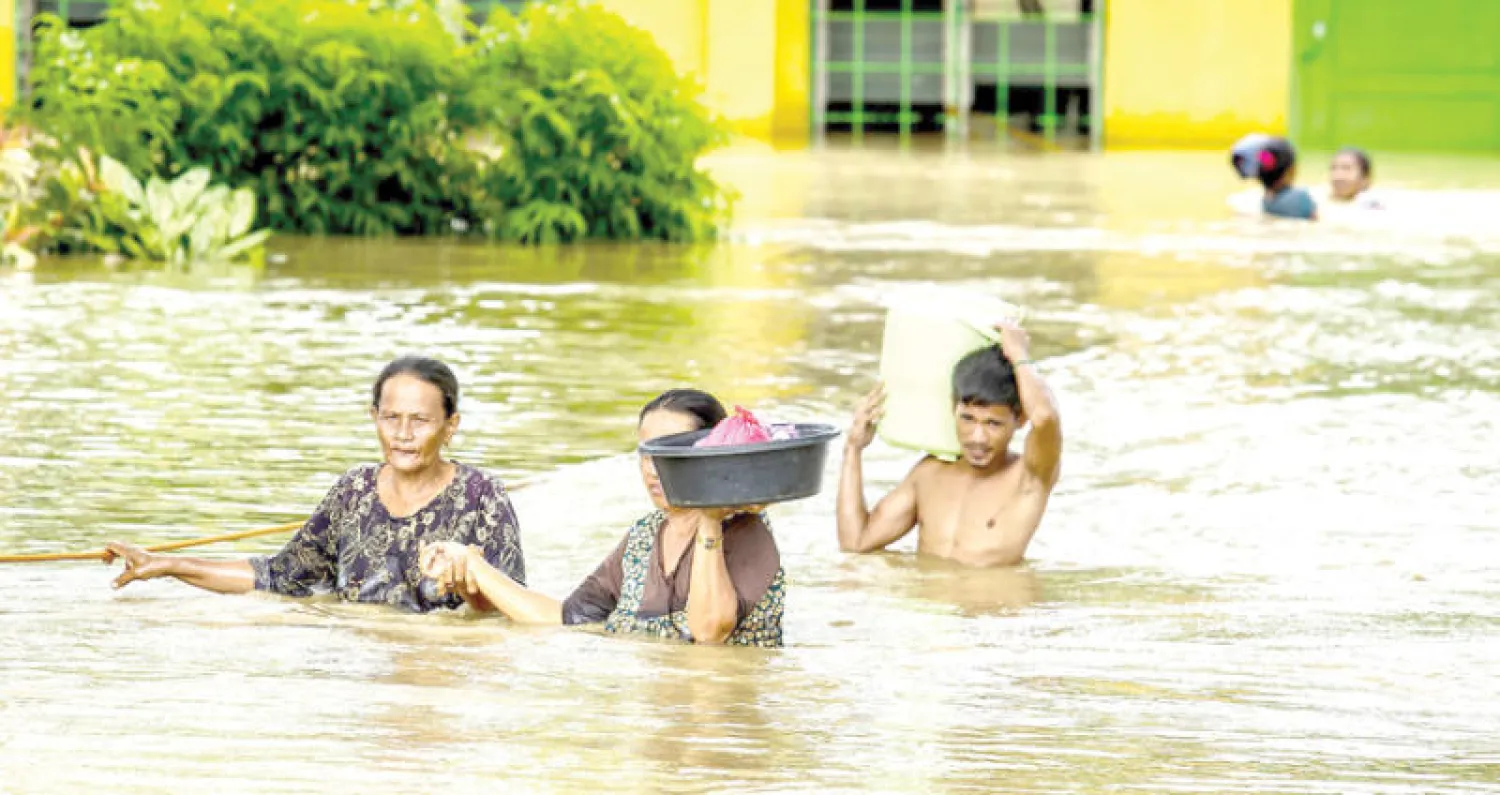 مواطنون ينزحون بسبب السيول التي أغرقت قريتهم في جزيرة مينداناو جنوب الفلبين أمس (أ.ف.ب)