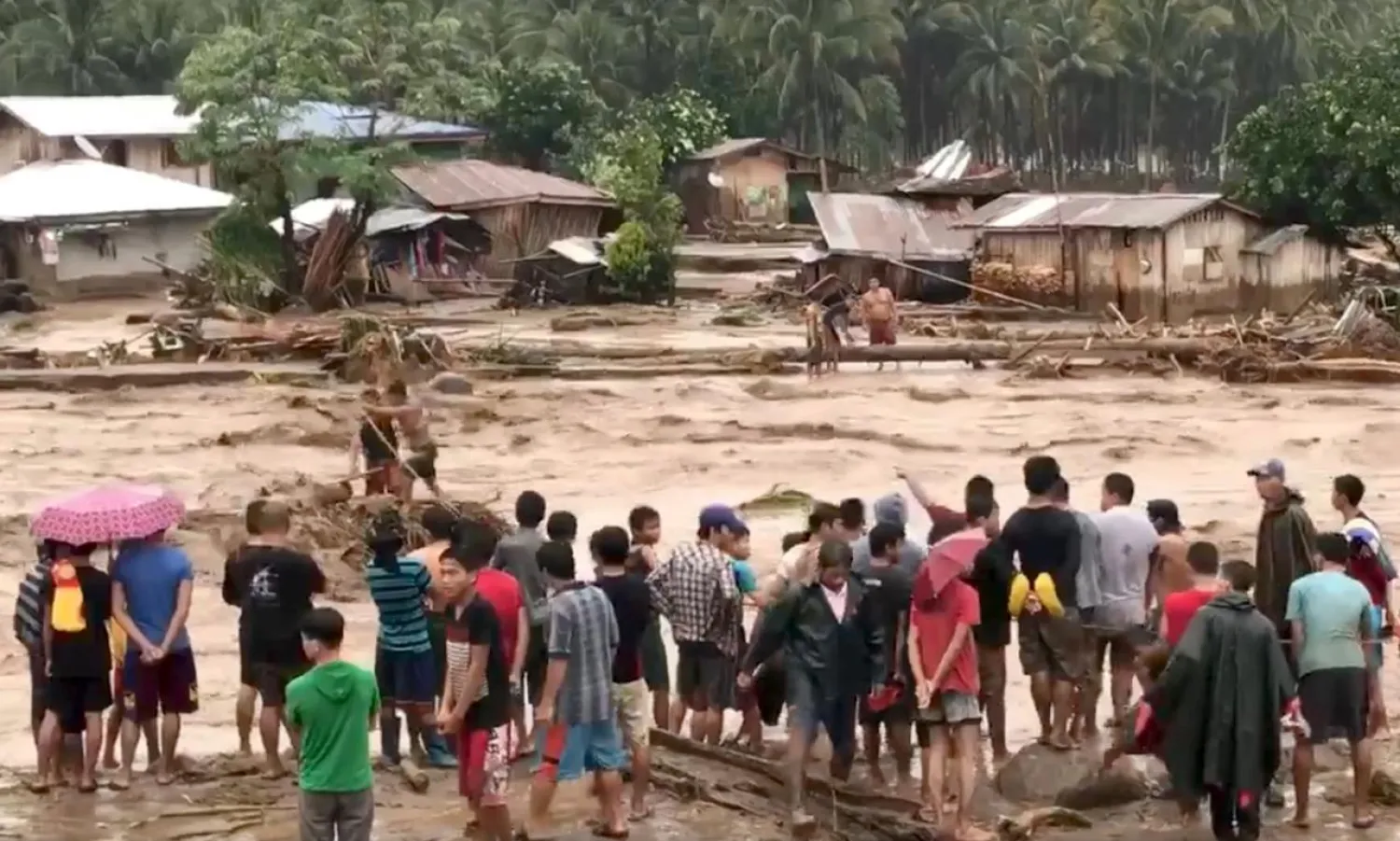 People help to rescue flood victims in Lanao del Norte, Philippines, December 22, 2017 in this image taken from video footage obtained from social media. Aclimah Cabugatan Disumala/via REUTERS