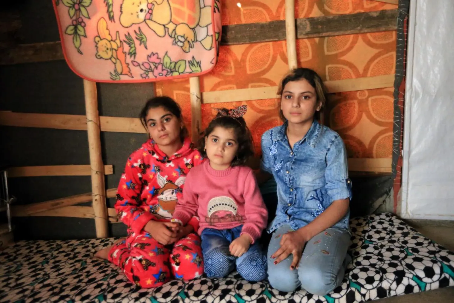 Yazidi girls Bushra, 12, Suhayla, 7, and Rosa, 13, who were reunited with their family after being enslaved by ISIS militants, pose for a photo at Sharya Camp in Duhuk, Iraq December 18, 2017. REUTERS/Ari Jalal