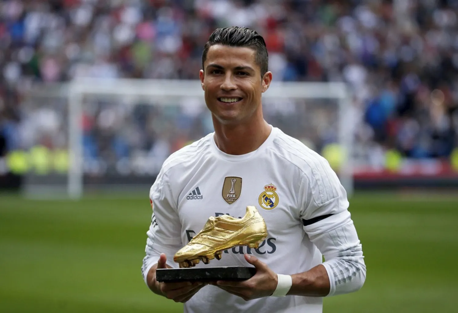 Real Madrid striker Cristiano Ronaldo poses with his fourth Golden Boot trophy. (Reuters)
