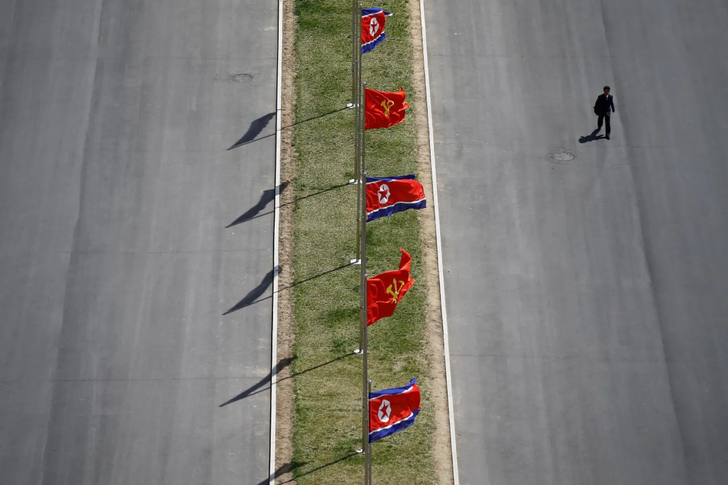 A man walks a street decorated with flags as North Korea prepared to mark the 105th anniversary of the birth of Kim Il-sung in April 2017. (Reuters)