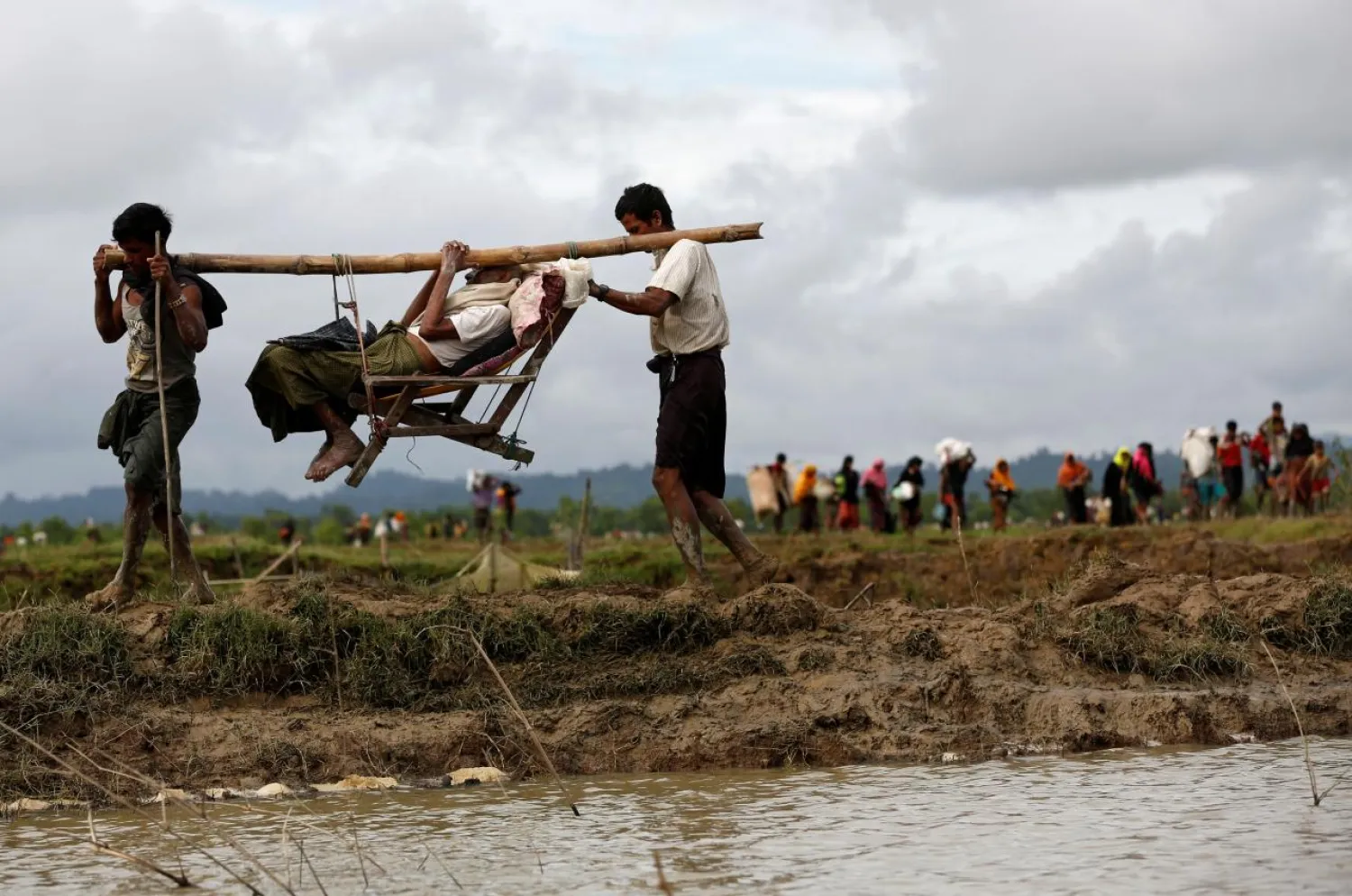 Rohingya refugees carry a man after traveling over the Bangladesh-Myanmar border in Teknaf, Bangladesh, September 1, 2017. (Reuters)