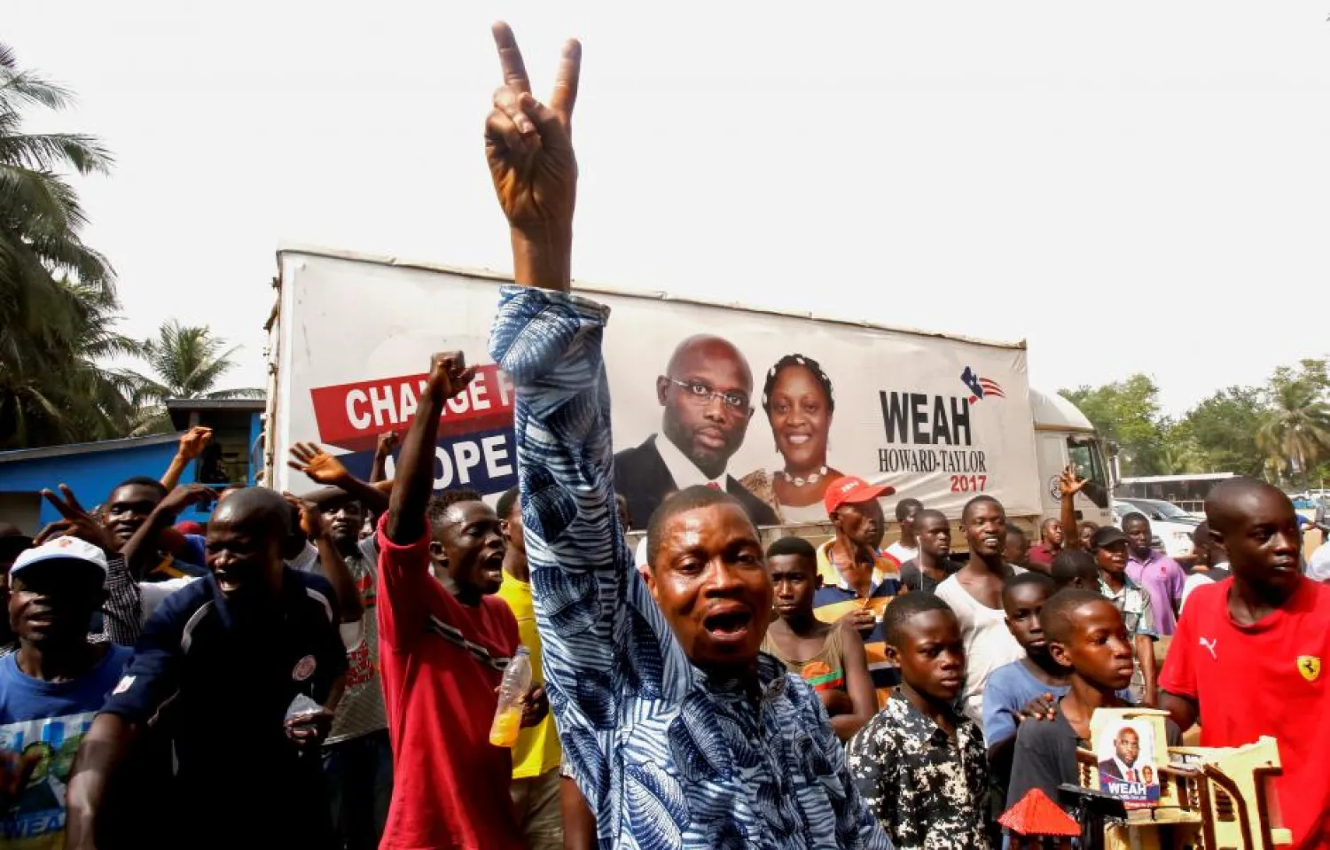 Supporters of George Weah, former football player and presidential candidate, celebrate after the announcement of the elections results in Monrovia, Liberia. (Reuters)