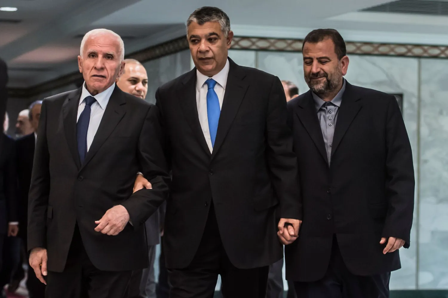 Khaled Fawzi (center), head of Egyptian intelligence, arrives with Fatah's Azzam al-Ahmad (left) and Hamas' Saleh al-Aruri before signing a reconciliation deal in Cairo. AFP file photo 