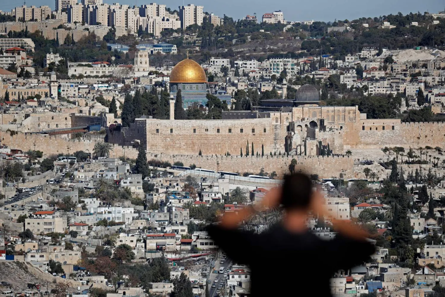 A man takes a picture of the Dome of the Rock mosque in Jerusalem. AFP file photo
