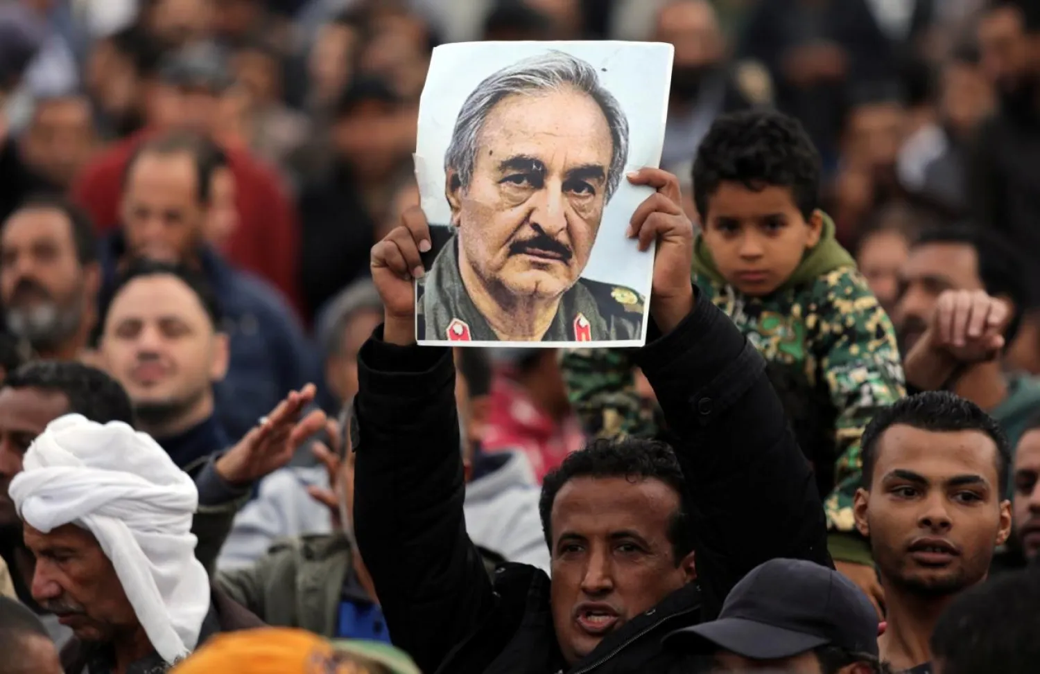 A man holds a poster of Eastern Libyan military commander Khalifa Haftar during a rally demanding Haftar to take over, in Benghazi, Libya, December 17, 2017. REUTERS/Esam Omran Al-Fetori
