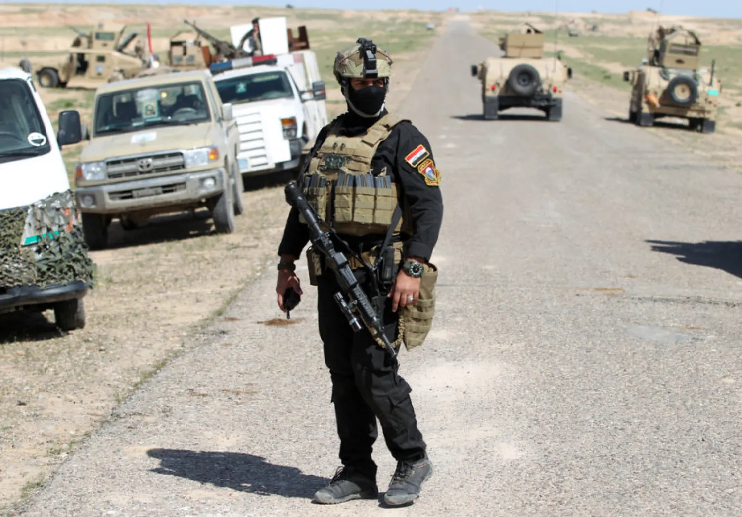 A heavily armed Iraqi soldier guards a road in northern Iraq near Mosul (AFP)