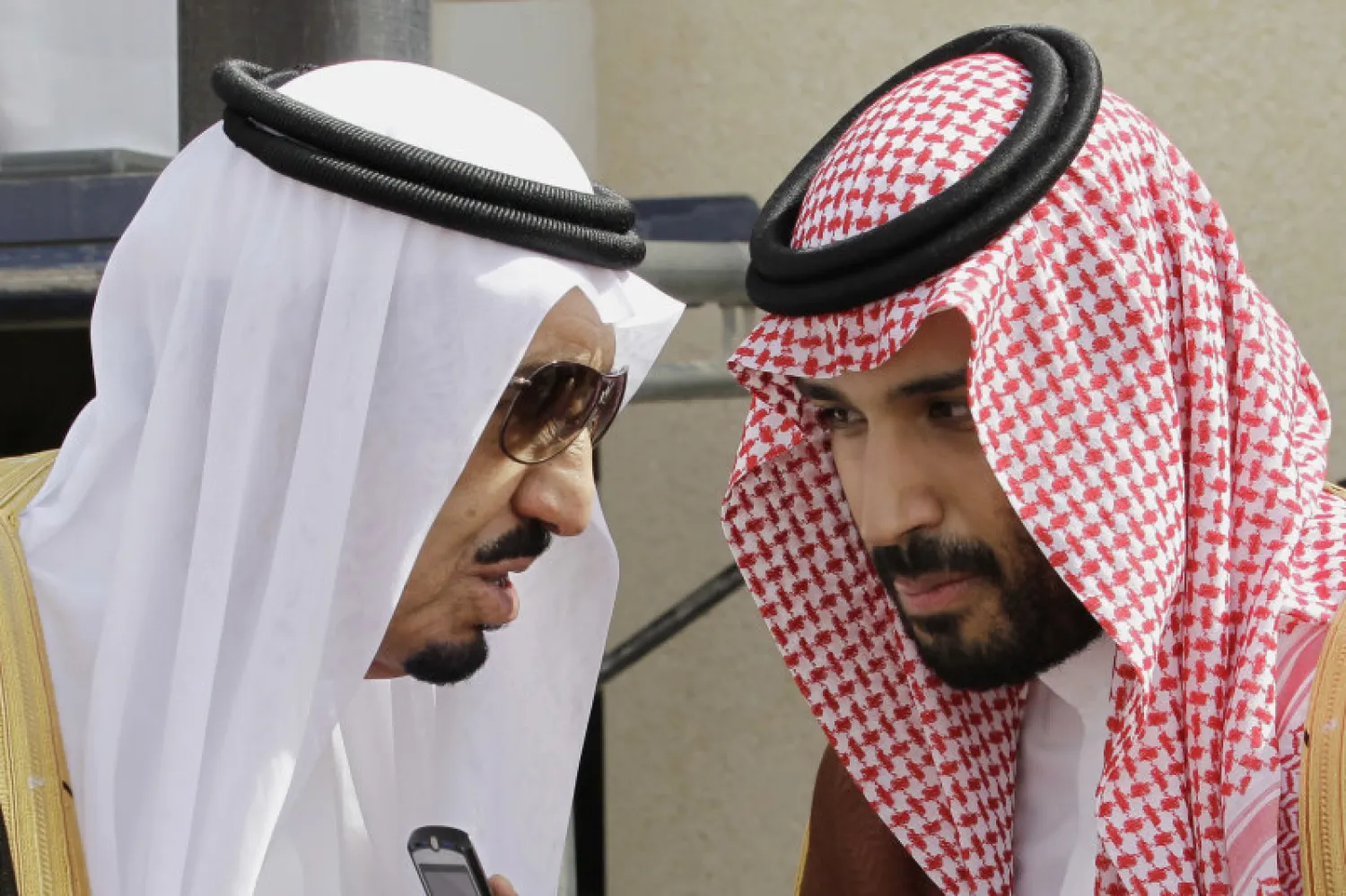 King Salman bin Abdulaziz Al Saud (L) speaks with his son Crown Prince Mohammed in Riyadh, Saudi Arabia. AP
