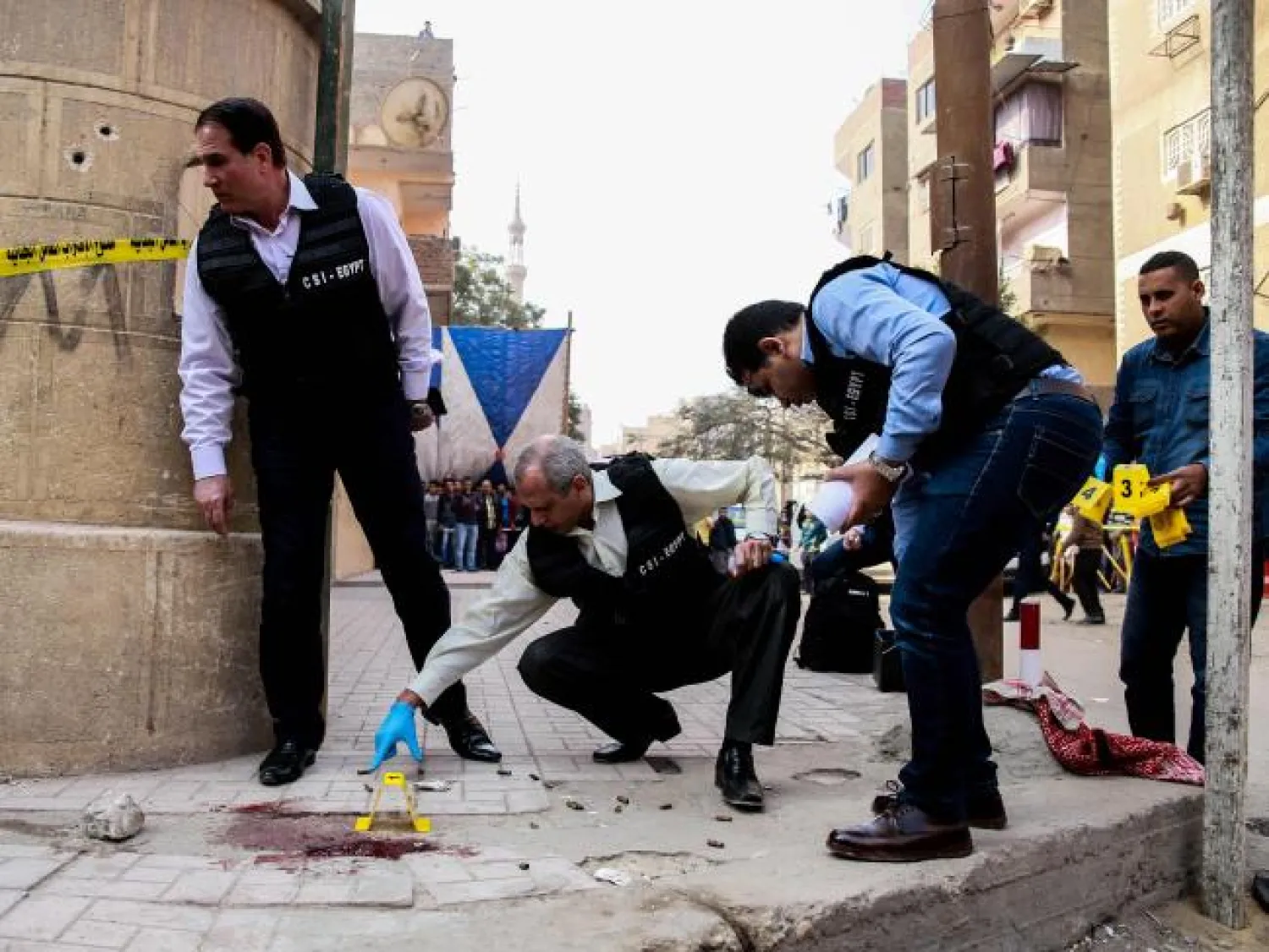  Egyptian security members and forensic police inspect the site of the attack. AFP/Samer Abdallah