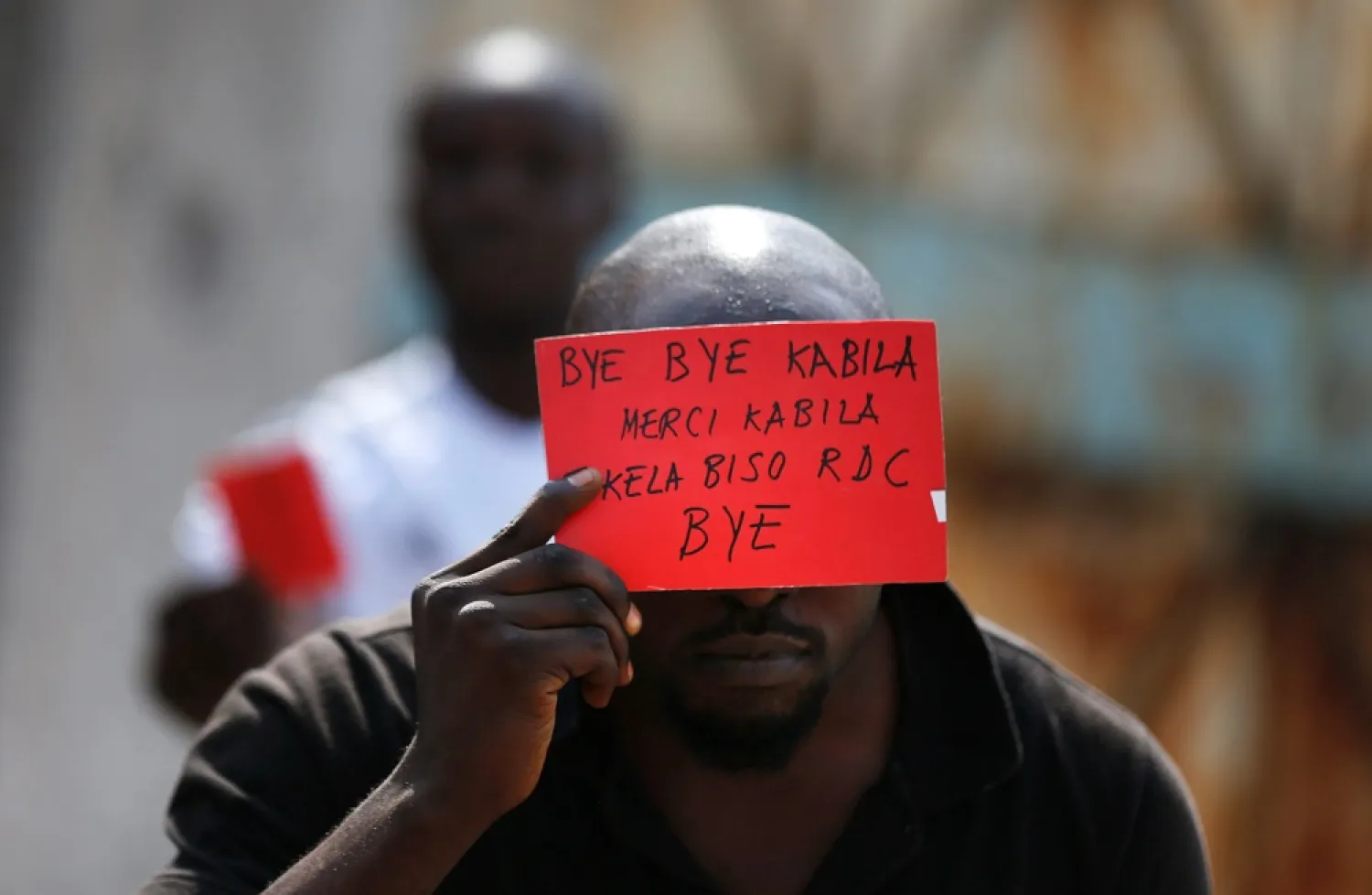 A Congolese opposition party supporter displays a red card against President Joseph Kabila in Kinshasa, Congo in 2016. (Reuters)