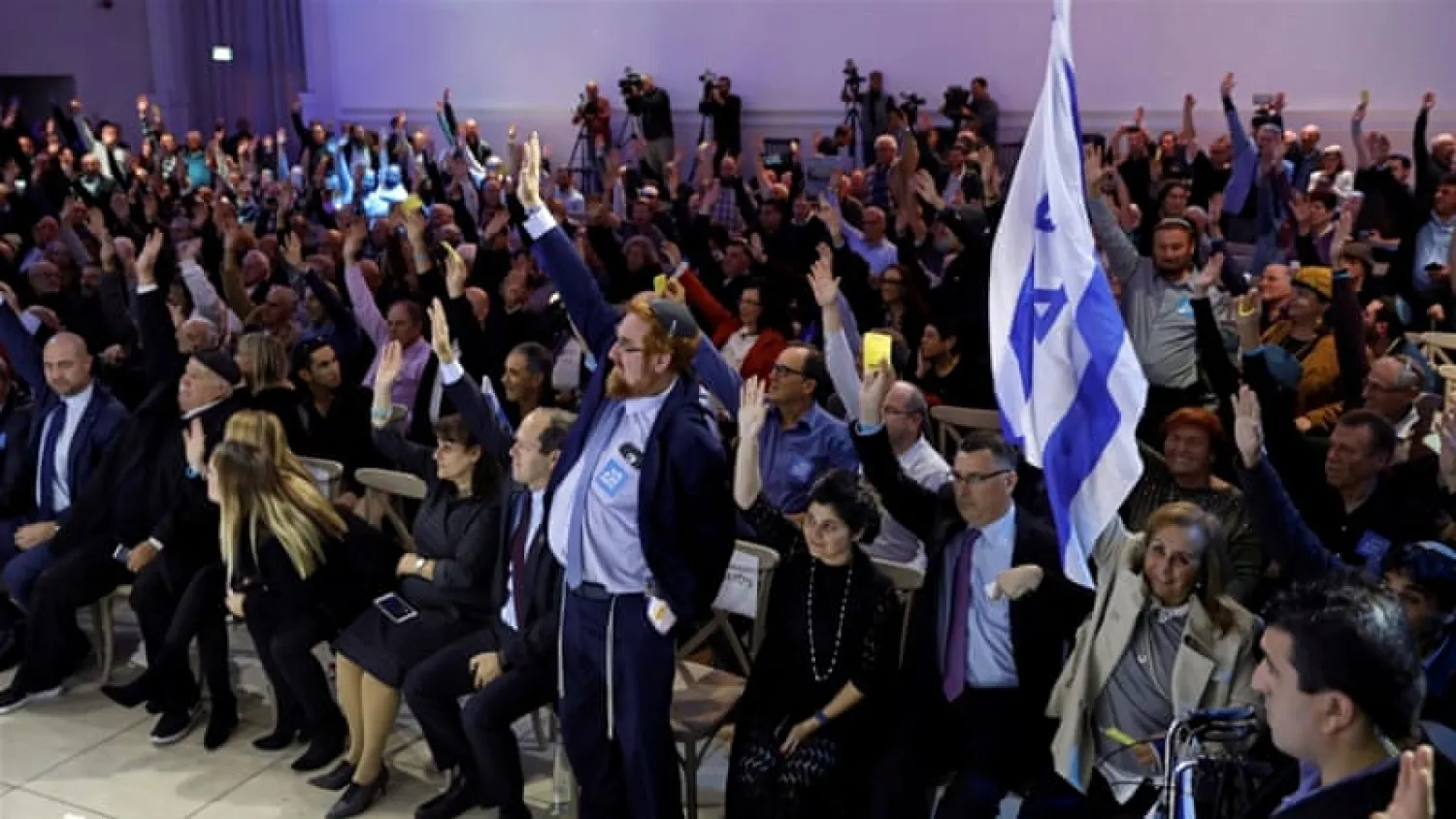 Party members vote during the Likud Central Committee meeting [Amir Cohen/Reuters]