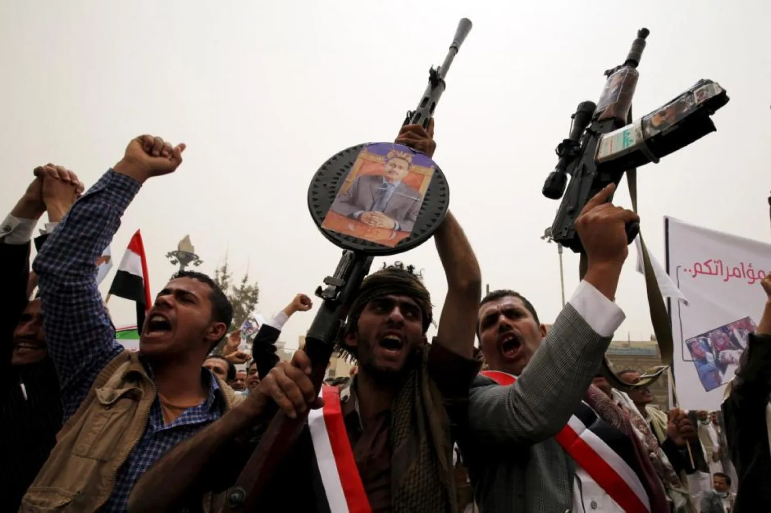 Supporters of Yemen's former President Ali Abdullah Saleh hold up their weapons during a rally in Sanaa in 2015. (Reuters)