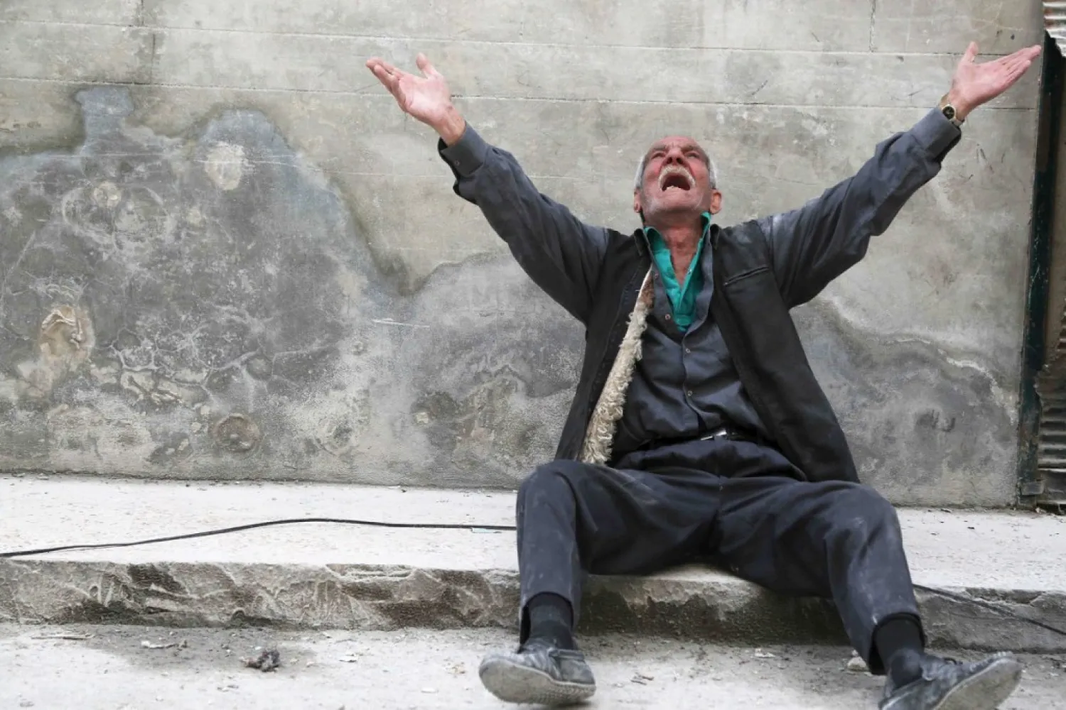 Man reacts at a site hit by what activists say was a barrel bomb dropped by Bashar al-Assad's regime, in Aleppo. (Reuters)