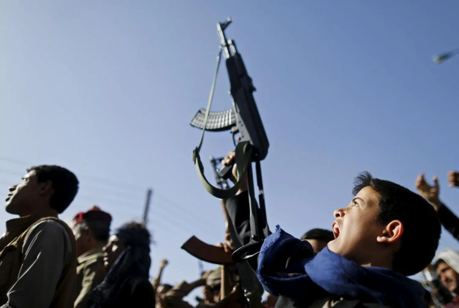A boy holds up a rifle as he joins followers of the Houthis in a rally in Sanaa. (Reuters)