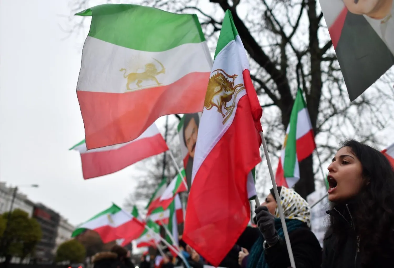 Protesters wave flags as they gather outside the Iranian Embassy in central London on January 2, 2018, in support of national demonstrations in Iran against the existing regime. (AFP)