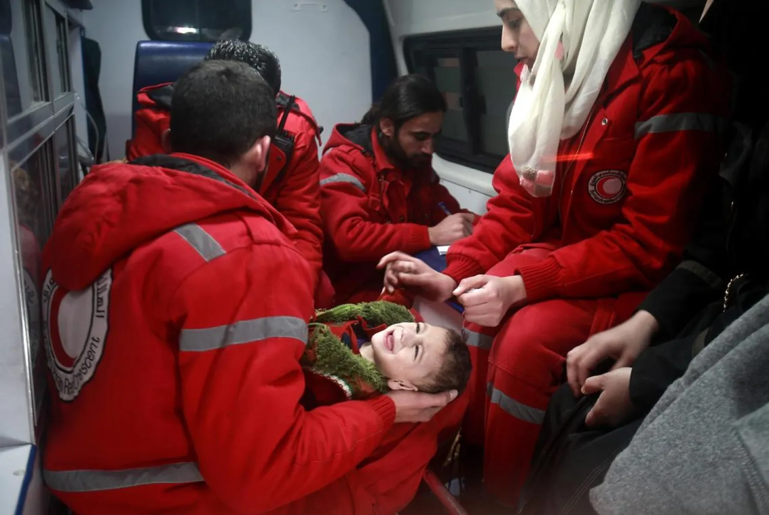 Syrian staff from the ICRC evacuate a baby in Douma, in the eastern Ghouta region of Syria. Abdulmonam Eassa/AFP