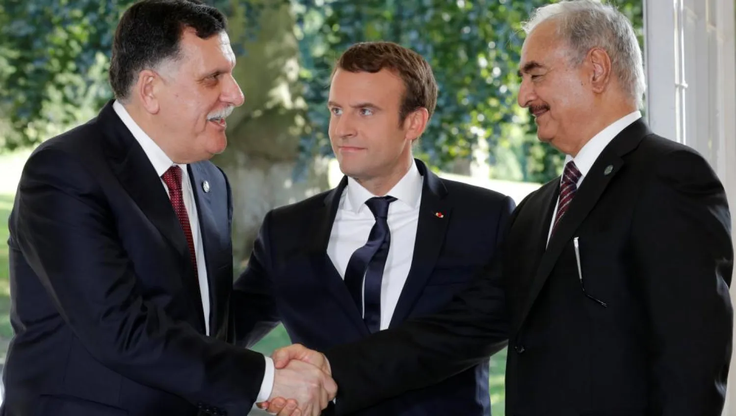 French President Emmanuel Macron with Libyan rival leaders Fayez al-Sarraj (L) and Khalifa Haftar (R). (Reuters)