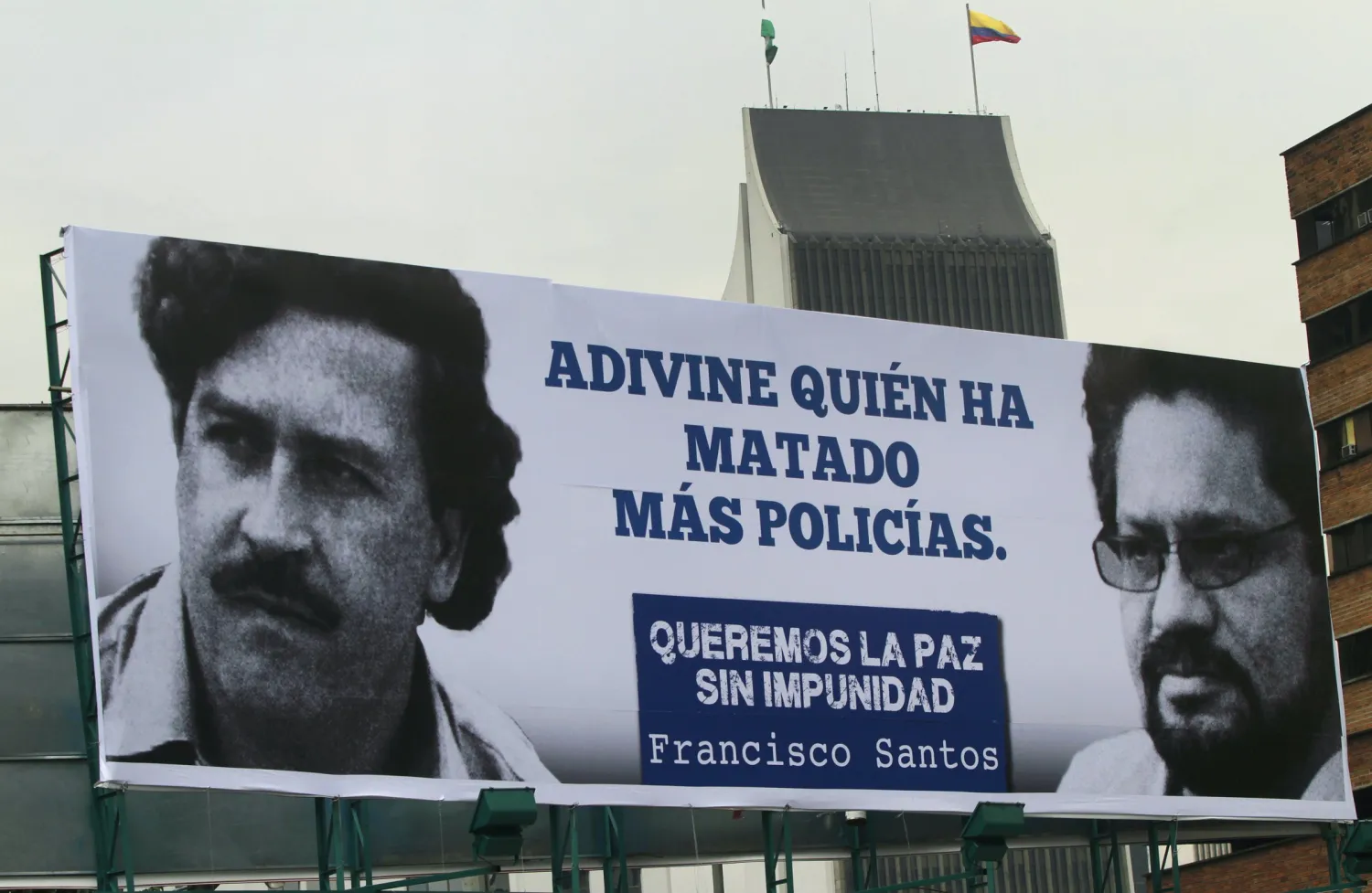 A sign comparing Pablo Escobar, left, with FARC leader and chief negotiator Ivan Marquez in Medellin, April 15, 2013. REUTERS/Albeiro Lopera 
