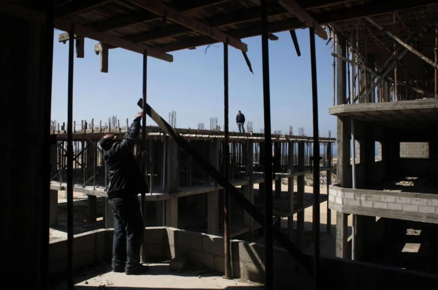 Palestinians inspect a building under construction in Gaza. (Reuters)