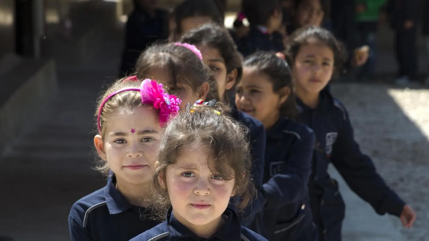 Syrian refugee children wait to enter their classroom at a non-formal school in the town of Saadnayel, in the Bekaa valley, Lebanon. (AP)