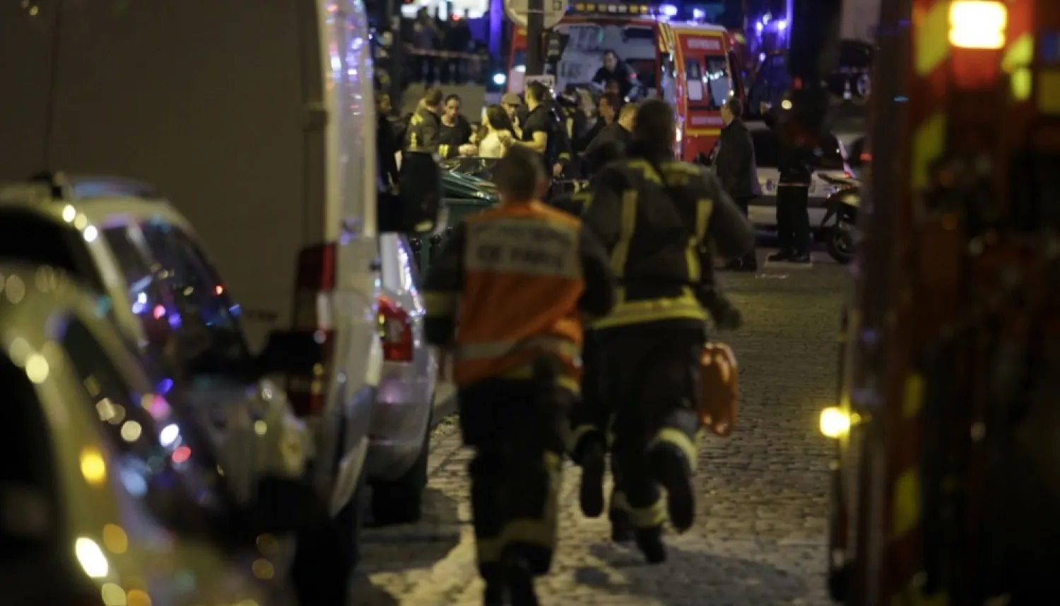 French security forces rush in as people are evacuated in wake of the ISIS attacks in Paris in November 2015. (AFP)