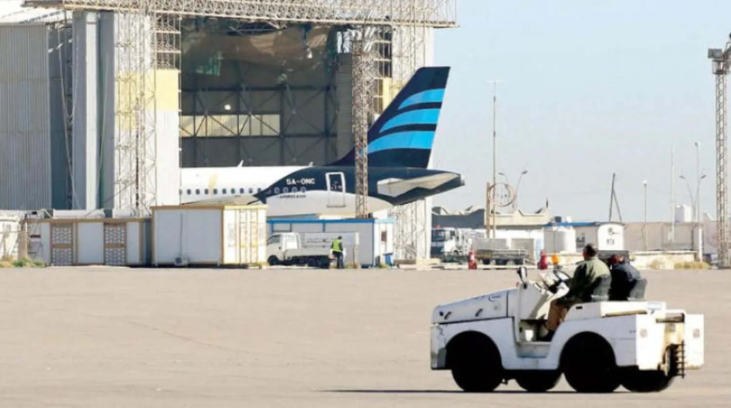 A Mitiga International Airport employee near an African plane that was hit by bullets during the armed confrontations (AFP)