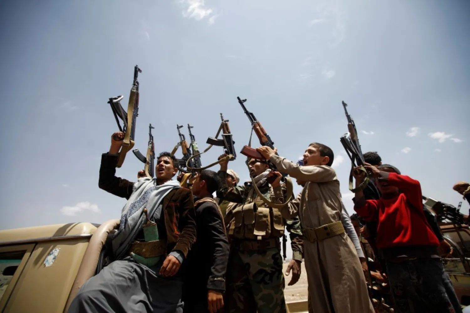 Houthi fighters react while riding on the back of a truck as they attend a tribal gathering in Sanaa, Yemen (File Photo: Mohamed al-Sayaghi, Reuters/Files)

