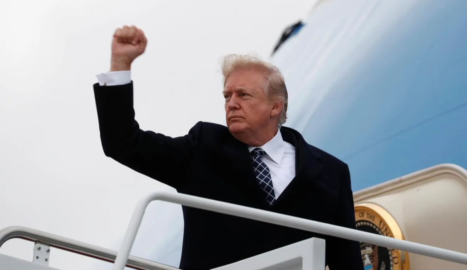 US President Donald Trump pumps his fist as he boards Air Force One upon departure from Joint Base Andrews in Maryland, US, January 12, 2018. PHOTO: Reuters