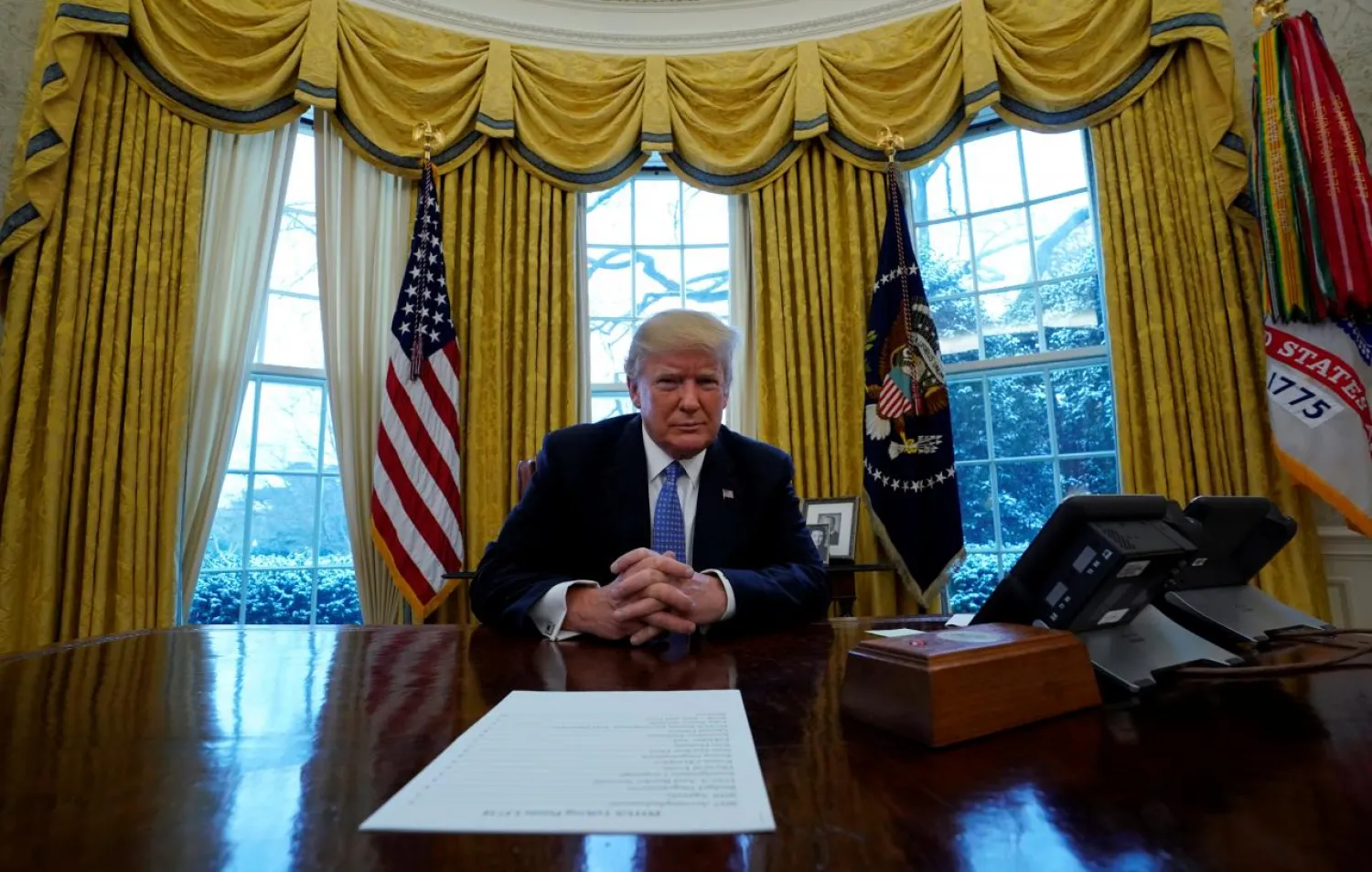 US President Donald Trump sits at the Resolute Desk during an interview with Reuters at the White House in Washington, U.S., January 17, 2018.