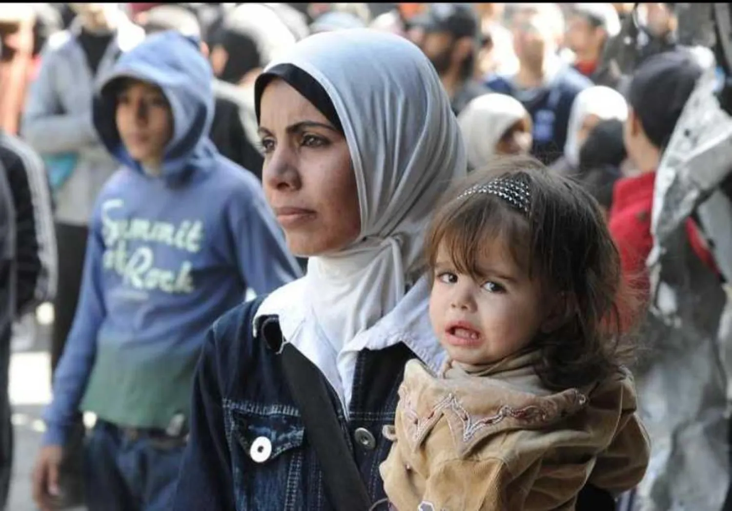 Palestinians wait to receive food aid distributed by UNRWA at al-Yarmouk camp. (photo credit: REUTERS)