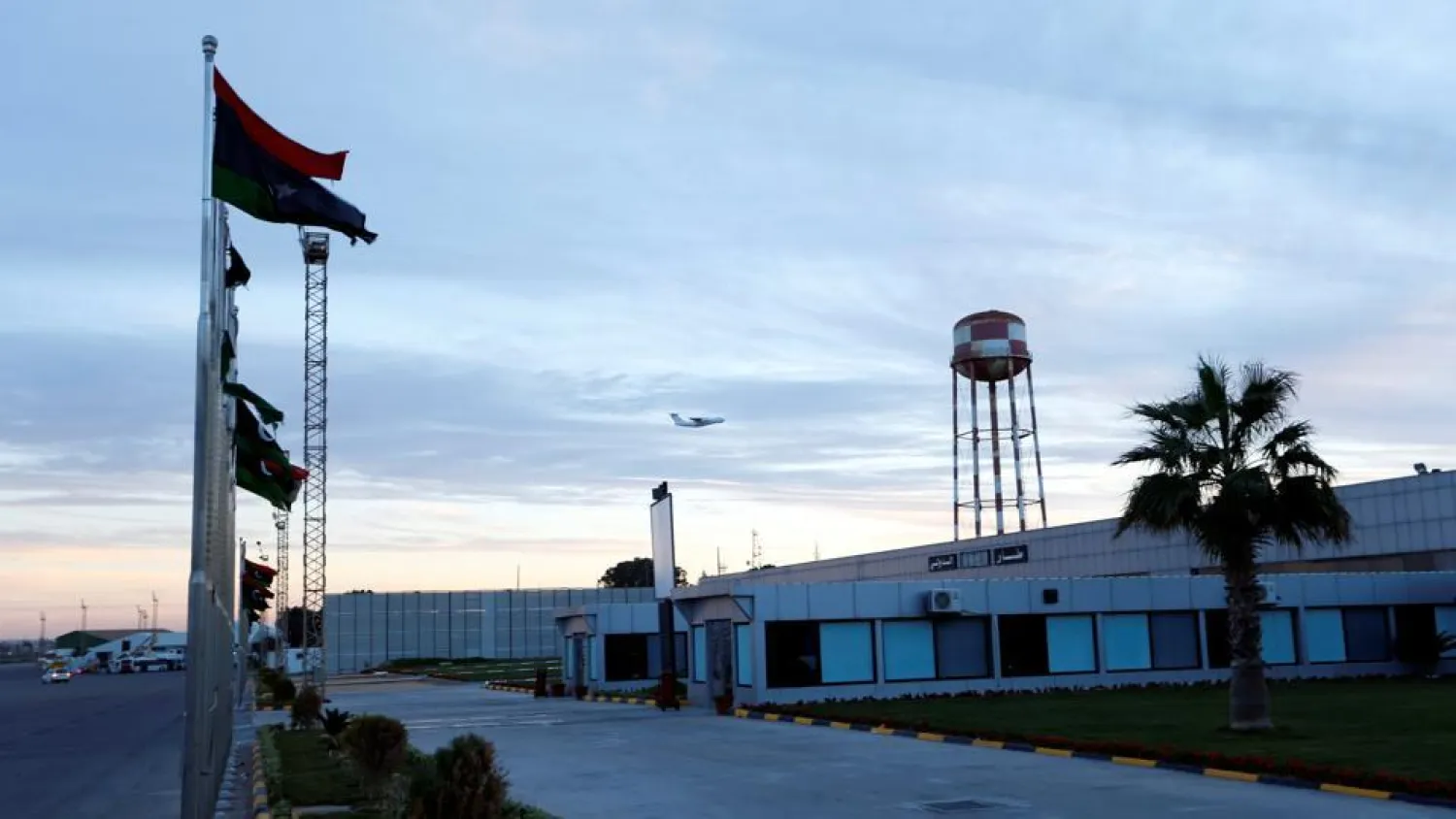 A plane flies over Mitiga airport following clashes, in Tripoli, Libya. (Reuters)