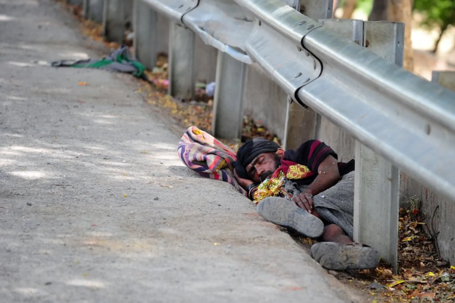 An Indian man rests on the road side during a hot summer day in Allahabad on May 22, 2015. (Sanjay Kanojia/AFP)