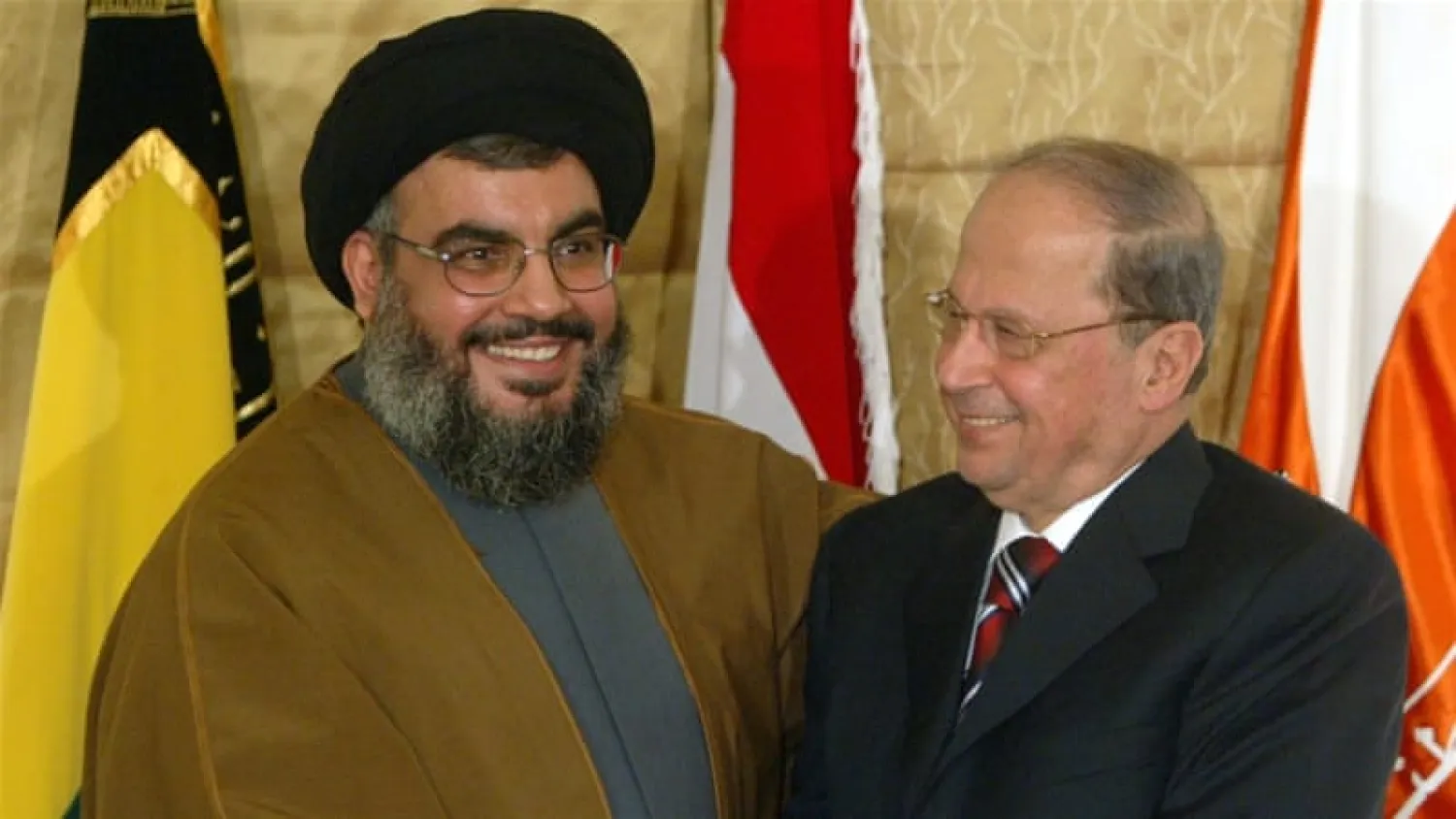  Hezbollah leader Hassan Nasrallah shakes hands with Christian leader General Michel Aoun during a news conference in Beirut, Lebanon on February 6, 2006 [Mohamed Azakir/Reuters]