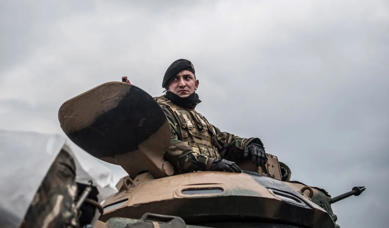 A Turkish soldier in a tank waits on the border before entering the Afrin region of Syria. (AFP)