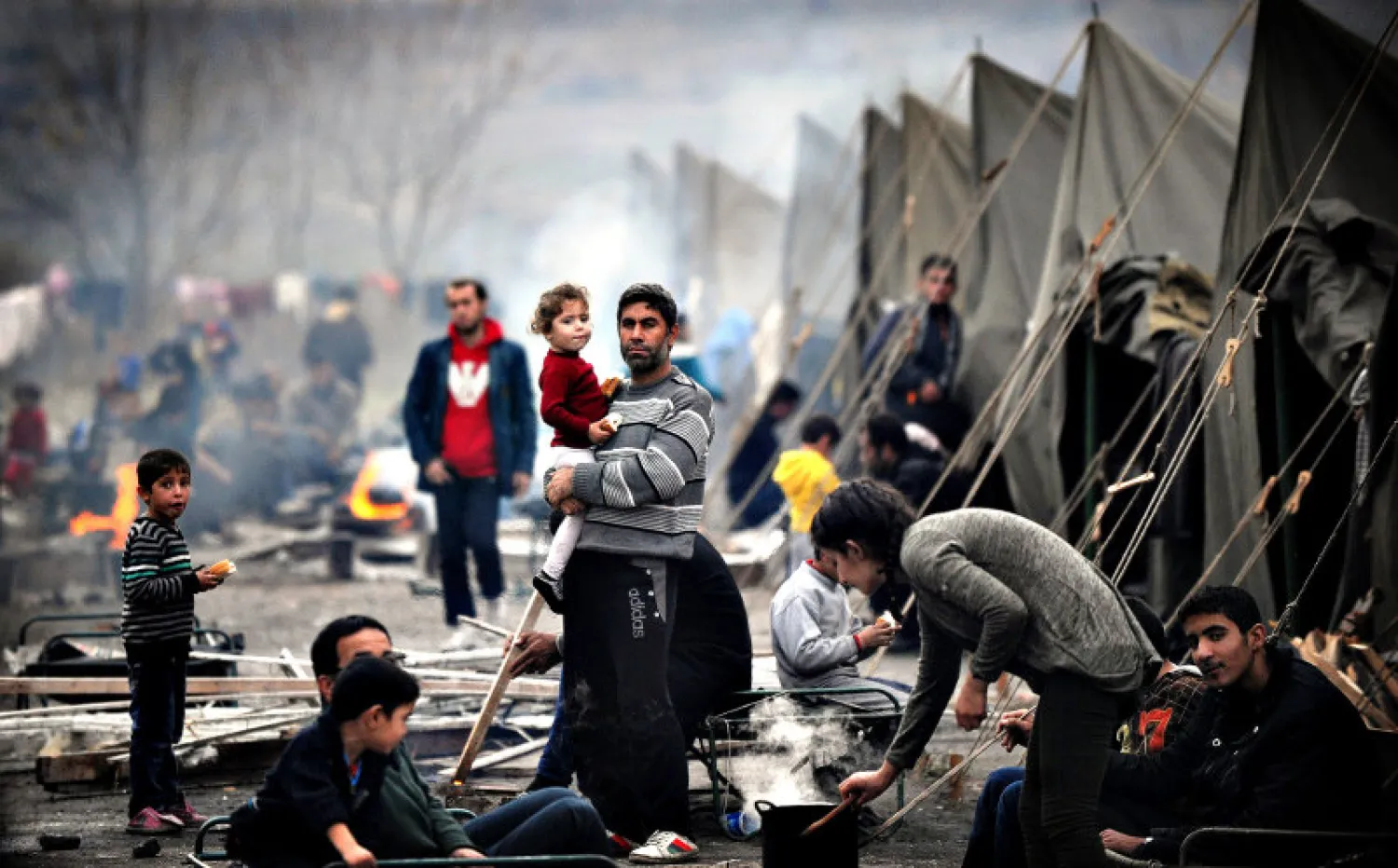 A Syrian refugee holds a baby in a Bulgarian refugee camp set in the town of Harmanli, southeast of Sofia on November 12, 2013. Credit: Nikolay Doychinova/ AFP