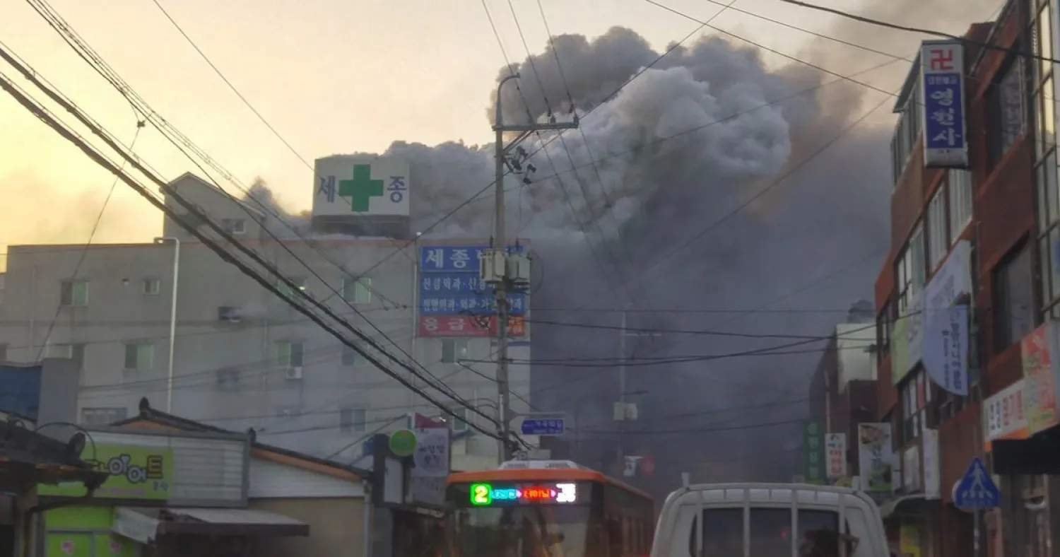 Heavy grey smoke rises into the air from a fire at a hospital building in Miryang on January 26, 2018. YONHAP / AFP