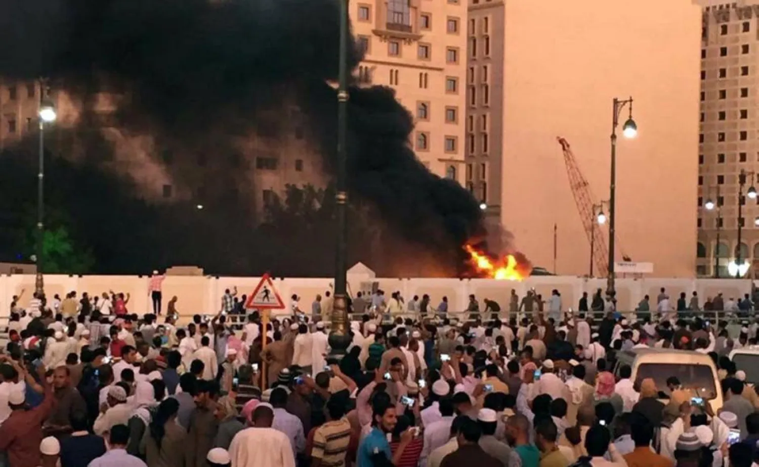 People gather after a suicide bomber detonated a device near the security headquarters of the Prophet's Mosque in Madinah, Saudi Arabia, July 4, 2016. (Reuters)