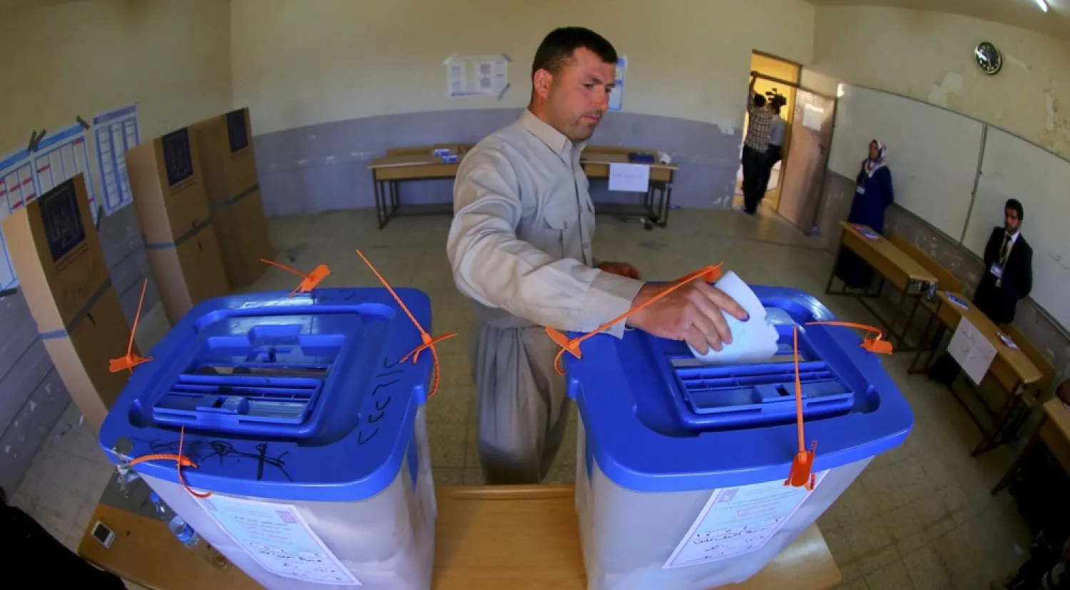 A man casts his vote into a ballot box at a polling station during voting for Iraqi parliamentary elections in 2014. (Reuters)