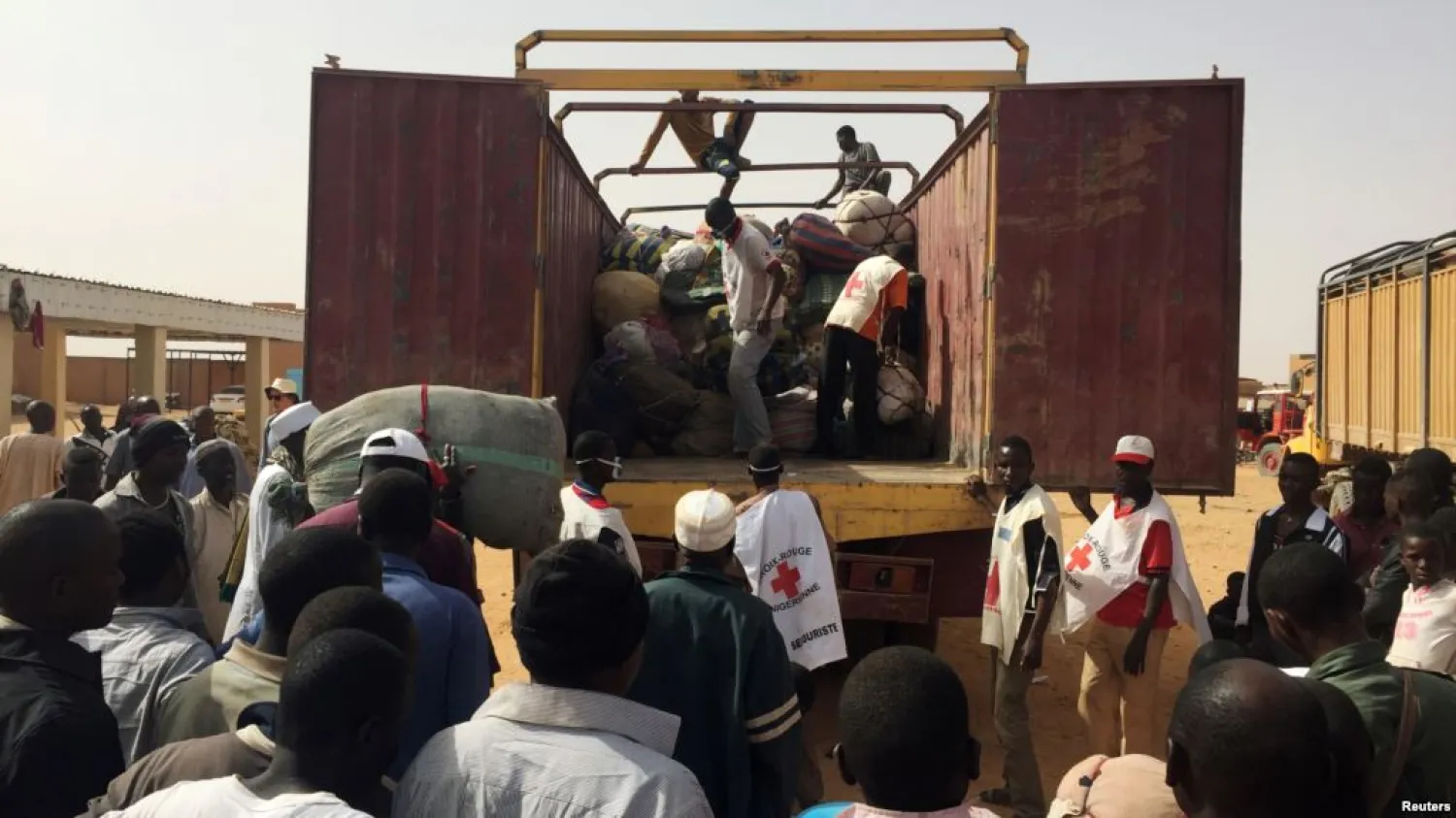 Migrants deported from Algeria gather to retrieve their belongings at the International Organization for Migration transit center in Agadez, Niger. (Reuters)