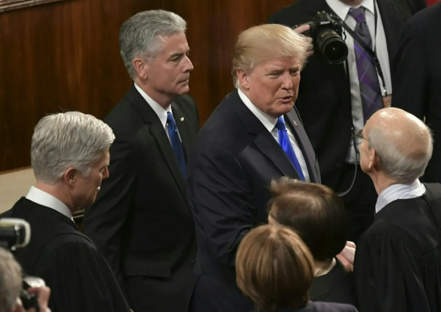 US President Donald Trump greets US Supreme Court justices (from L-R) Neil Gorsuch, Sonia Sotomayor and Stephen Breyer following his State of the Union address in the House Chamber of the US Capitol in Washington, DC on January 30, 2018. Mandel NGAN / AFP