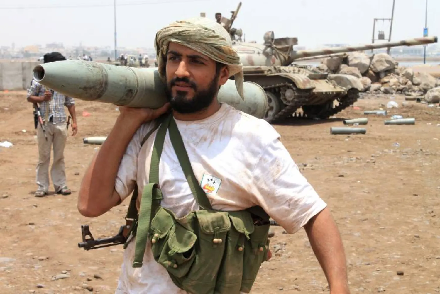 A Yemeni supporter of the separatist Southern Movement rests a tank shell on his shoulder in the city of Aden. AFP
 